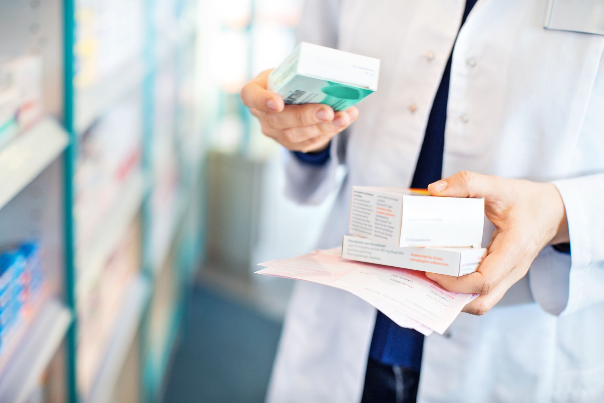 Pharmacist holding medication to ensure generic releases and inventory management