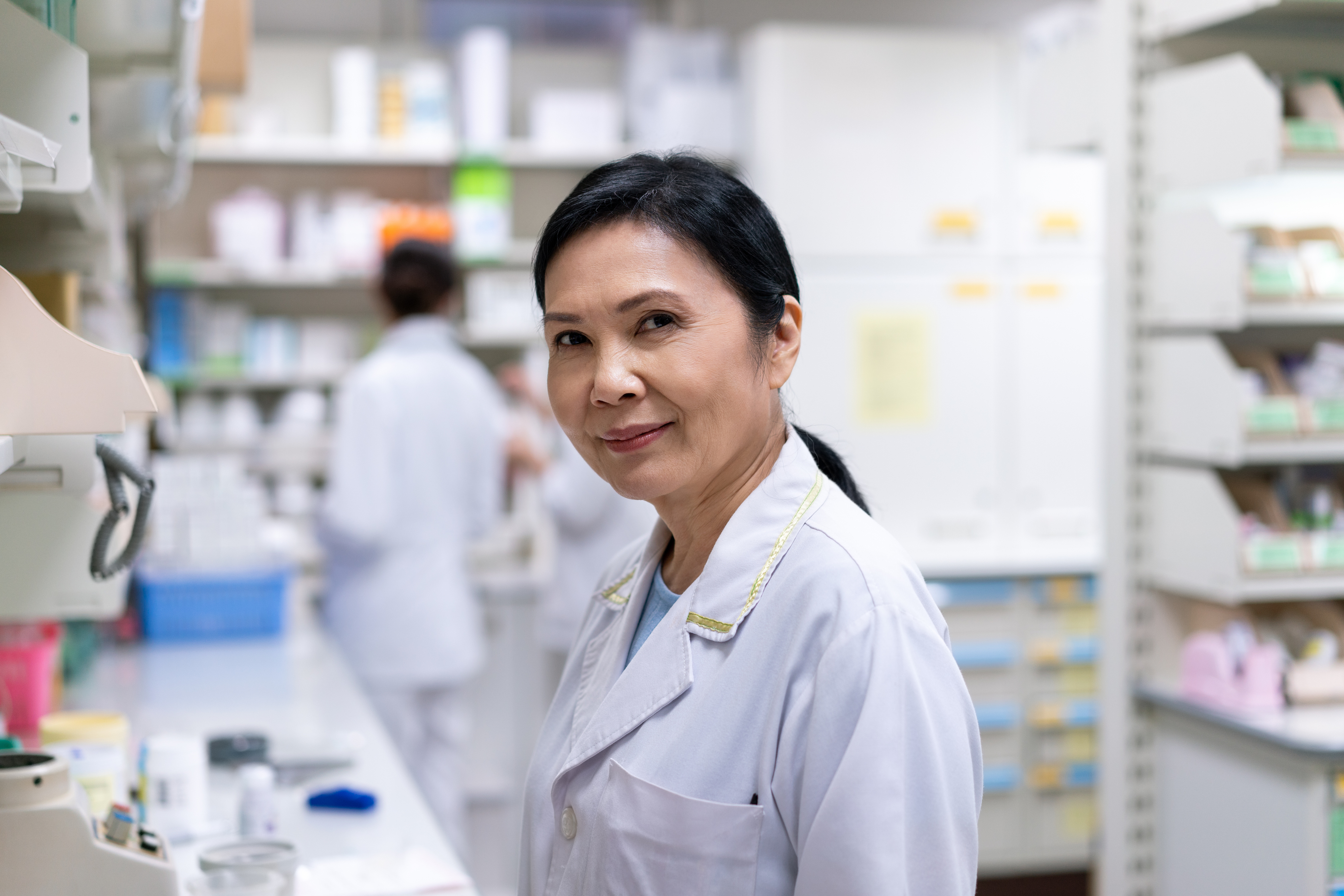 female pharmacist using replenishment management to increase inventory productivity in pharmacy