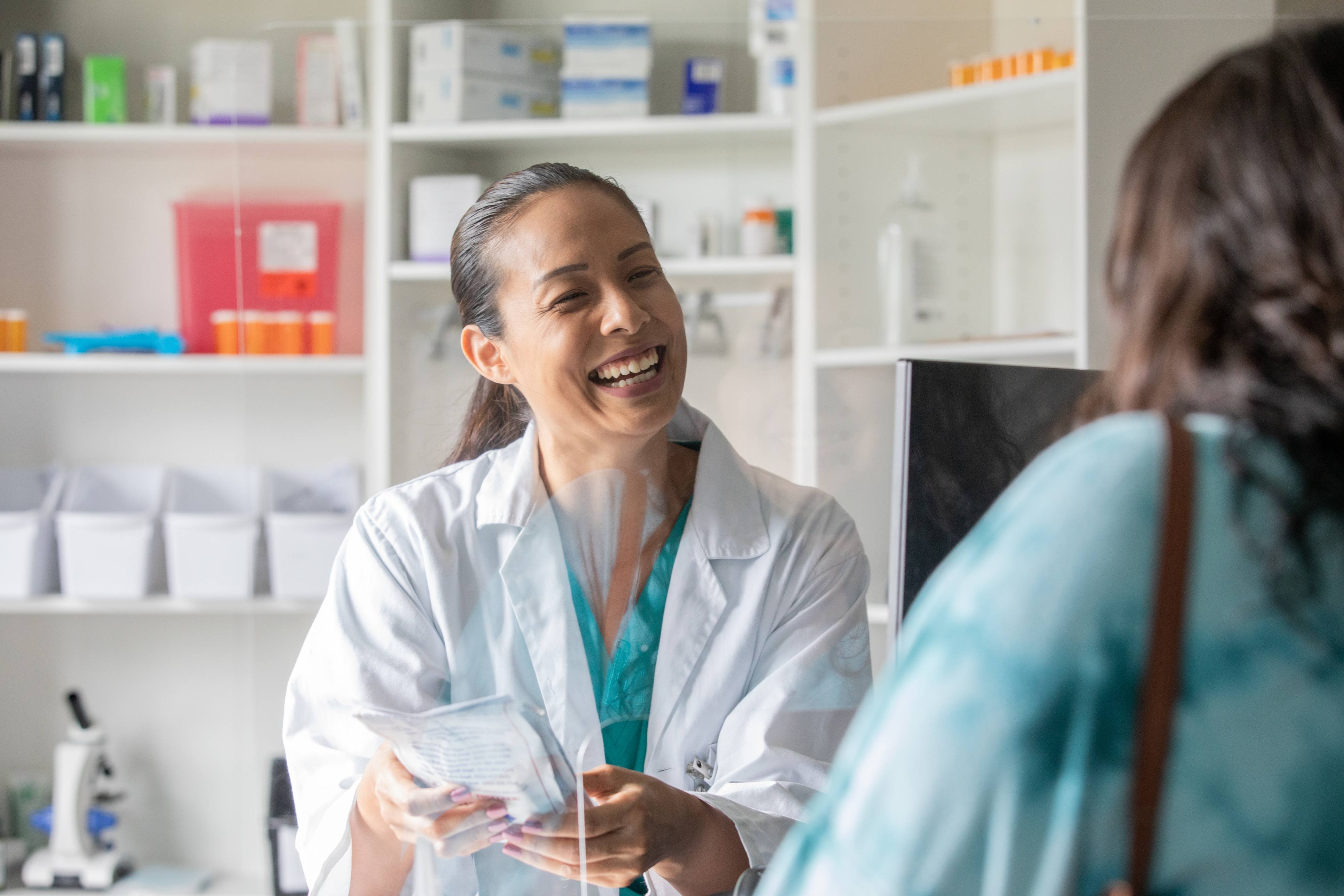 Pharmacist filling prescription refill for patient providing service and satisfaction with ontime medication