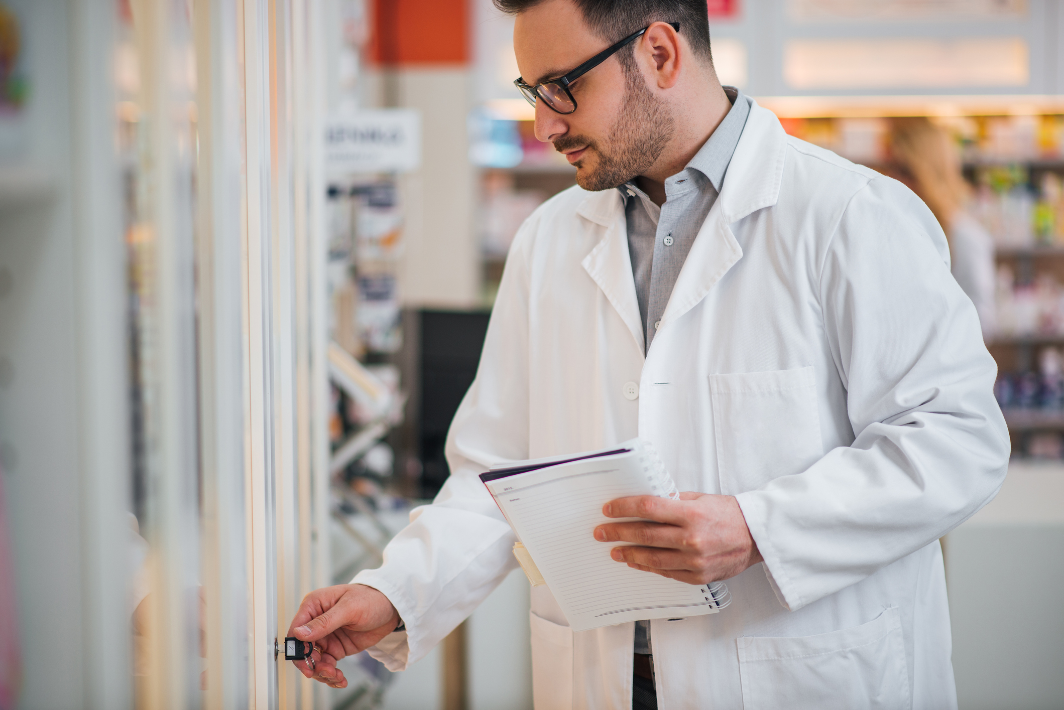 male Pharmacist monitoring controlled substances and high-value medications