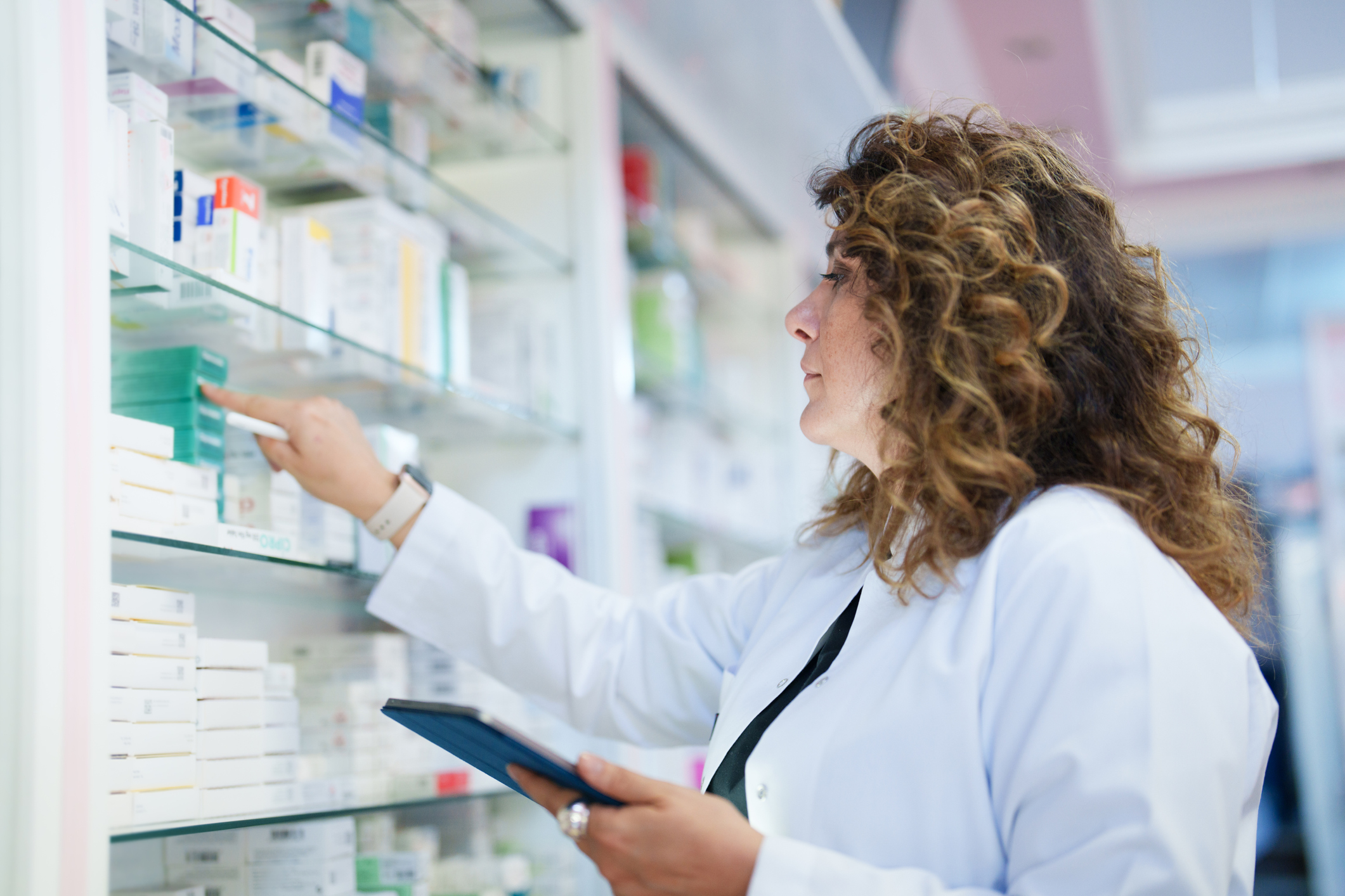 Pharmacist using a digital tablet to do inventory in hospital or health system pharmacy